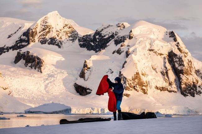 Camper on Antarctica sets up their tent 