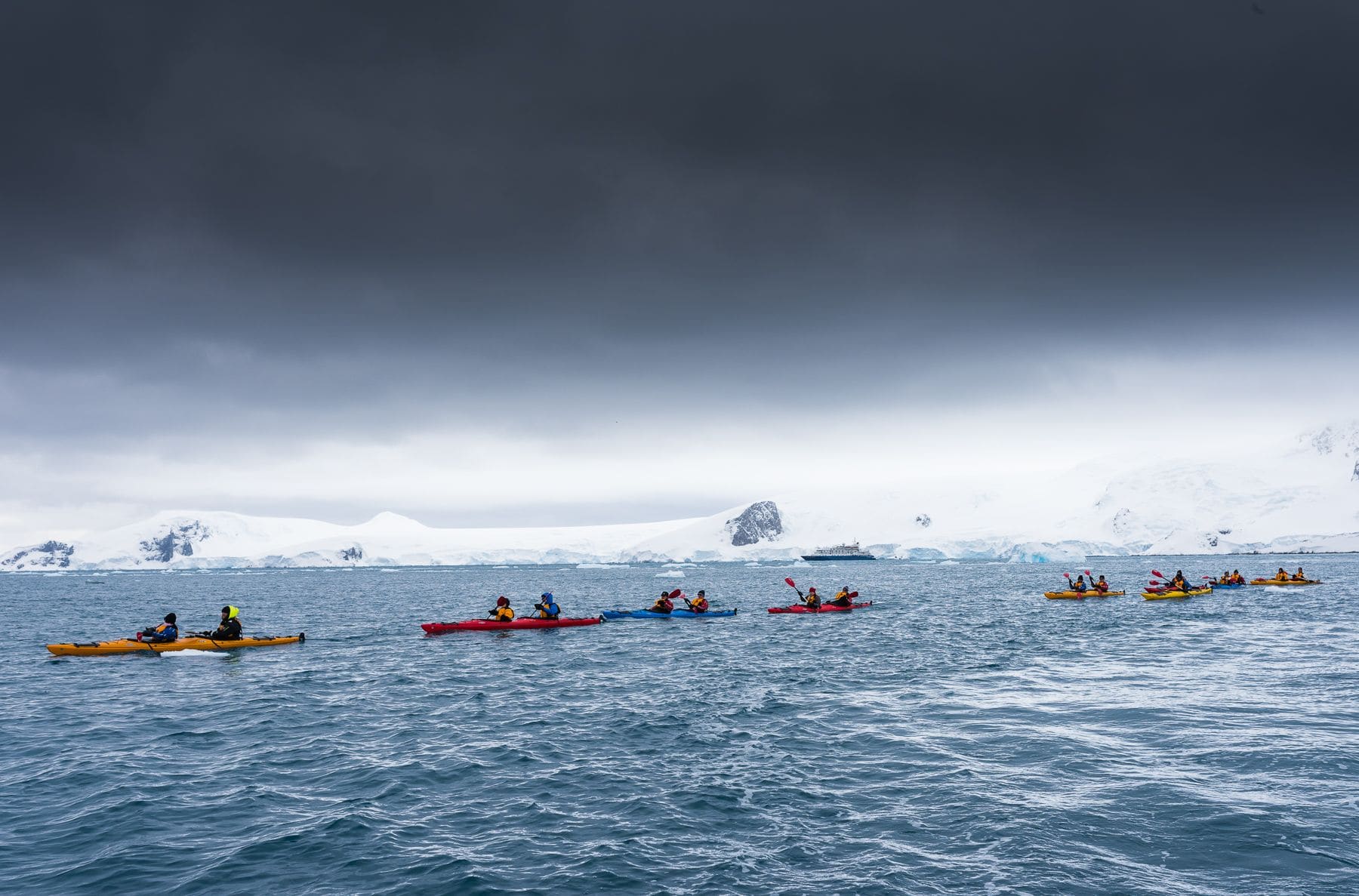 Kayakers on the icy Arctic water