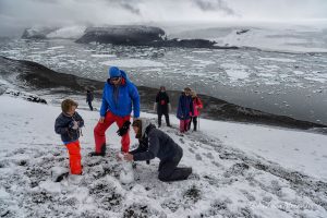 Antarctic travelers make a snowman