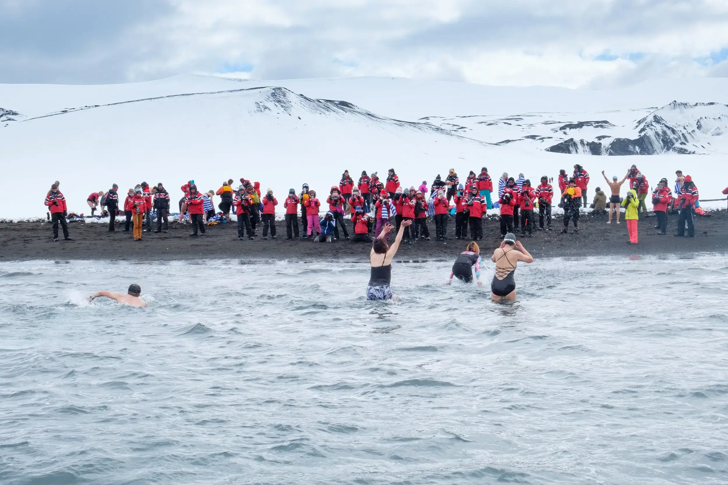 tourists on antarctica cruise vactions are enjoying themselves by doing swimming activity